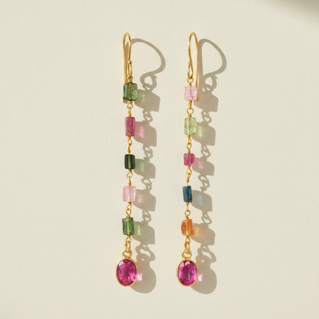 Gold-tone dangle earrings with multicolor faceted stones and pink round drop