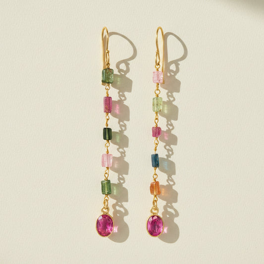 Gold-tone dangle earrings with multicolor faceted stones and pink round drop