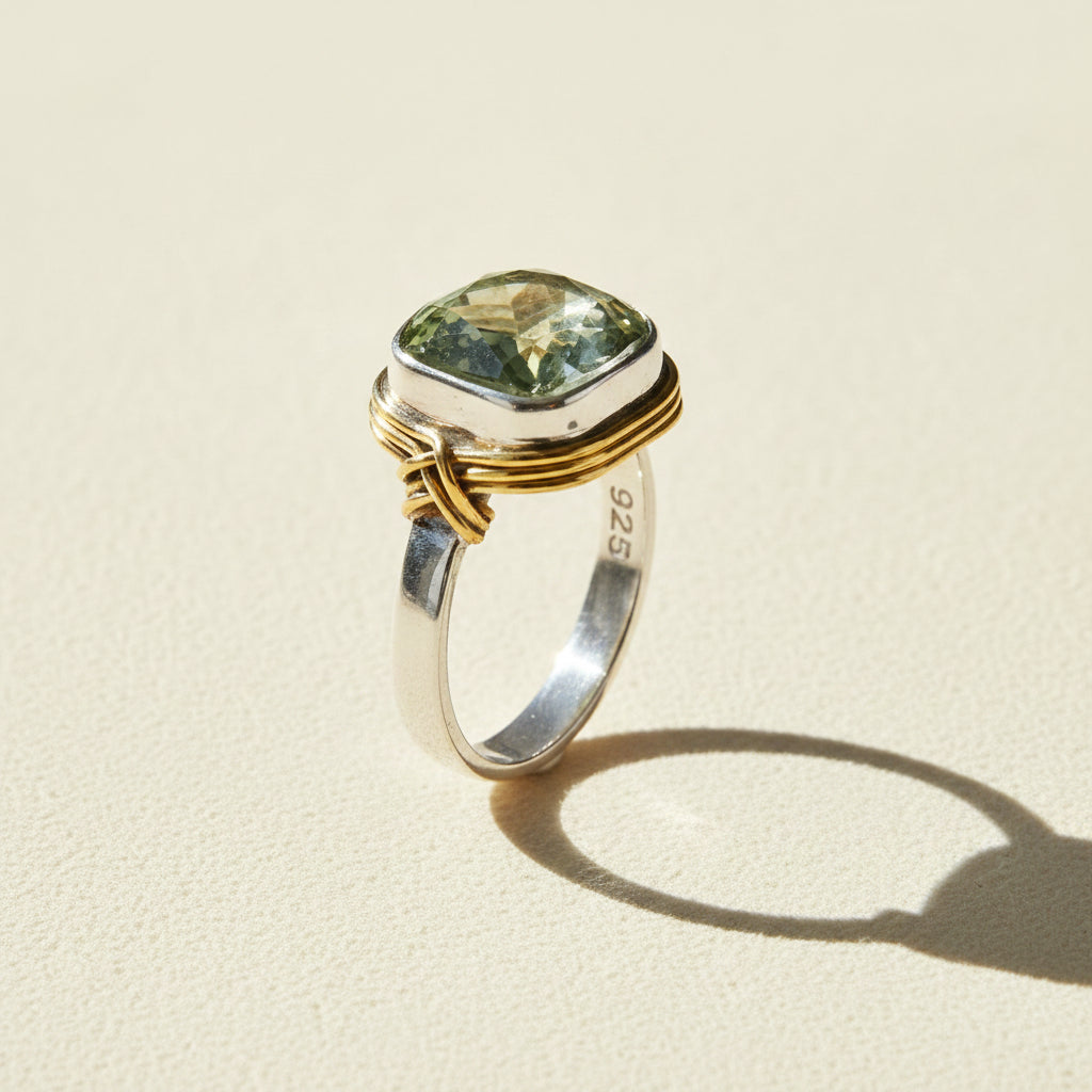Two-tone ring with rectangular pale green gemstone and inner 925 stamp on band