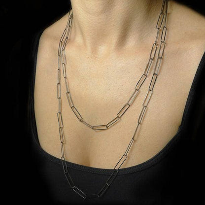 Layered paperclip-link chain necklace with three strands, silver-tone hardware.
