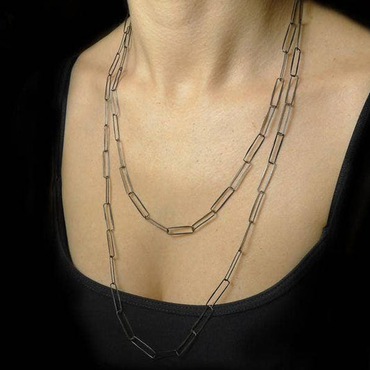 Layered paperclip-link chain necklace with three strands, silver-tone hardware.