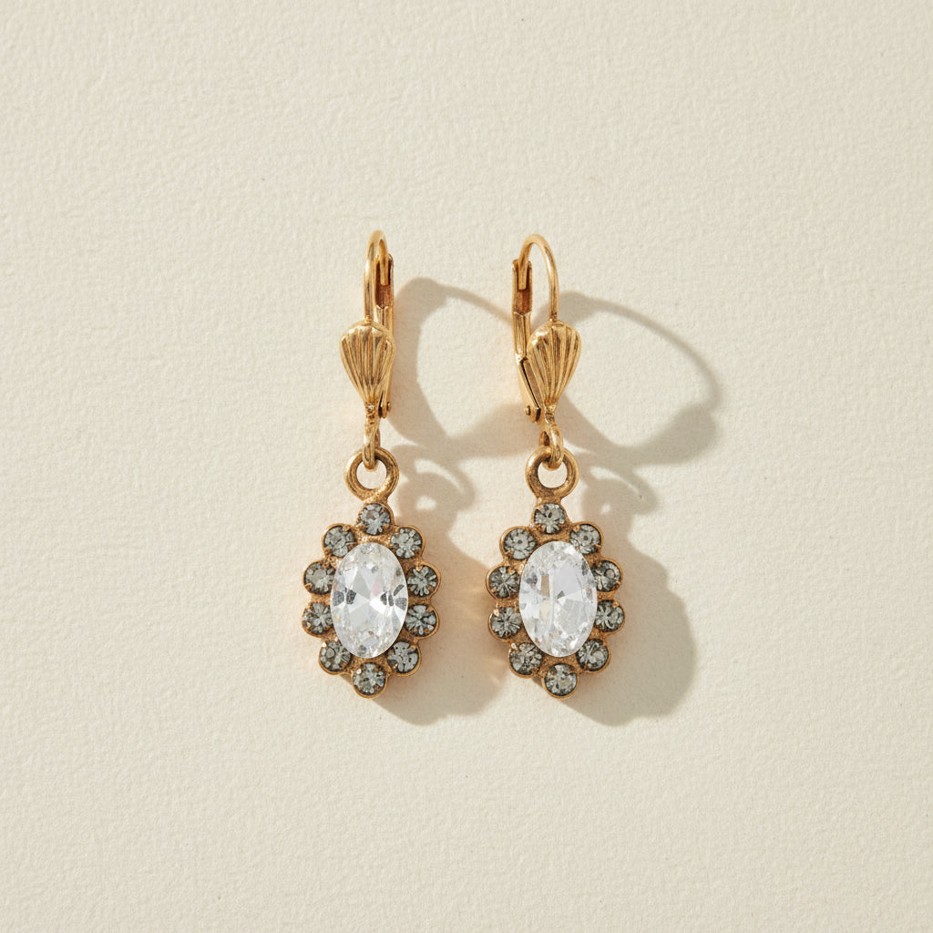 Gold-tone flower drop earrings with clear crystal center and small stone halo