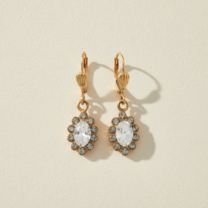 Gold-tone flower drop earrings with clear crystal center and small stone halo
