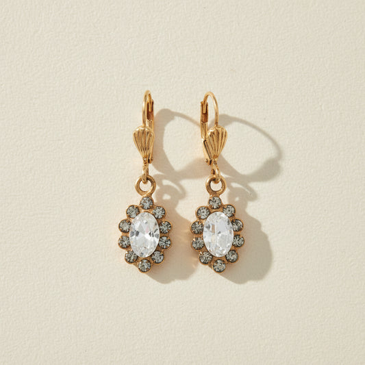 Gold-tone flower drop earrings with clear crystal center and small stone halo