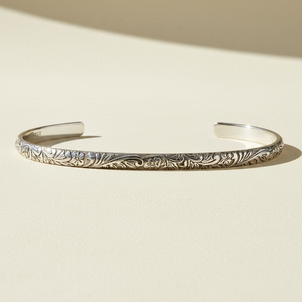 Sterling silver floral cuff bracelet with engraved vine and leaf pattern
