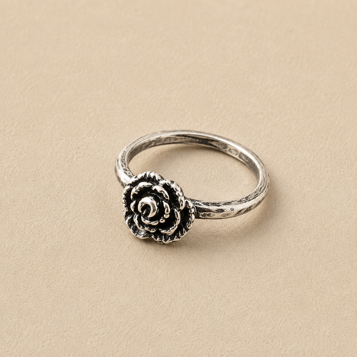 Sterling silver ring with a single rose-style flower medallion