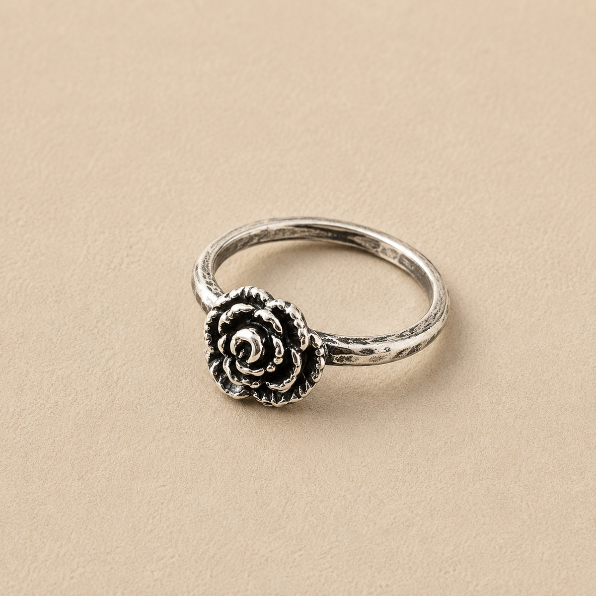Sterling silver ring with a single rose-style flower medallion