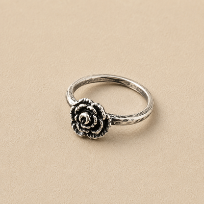 Sterling silver ring with a single rose-style flower medallion