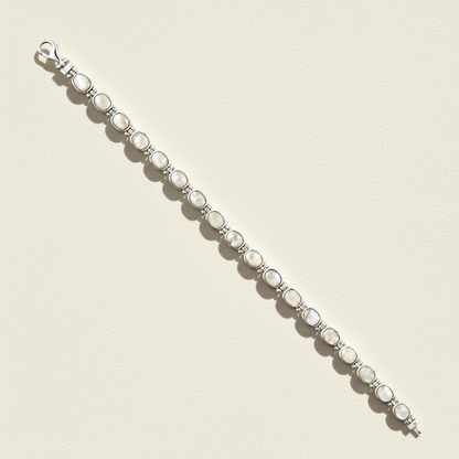 Silver reversible bracelet with white oval cabochons and dark oval accents