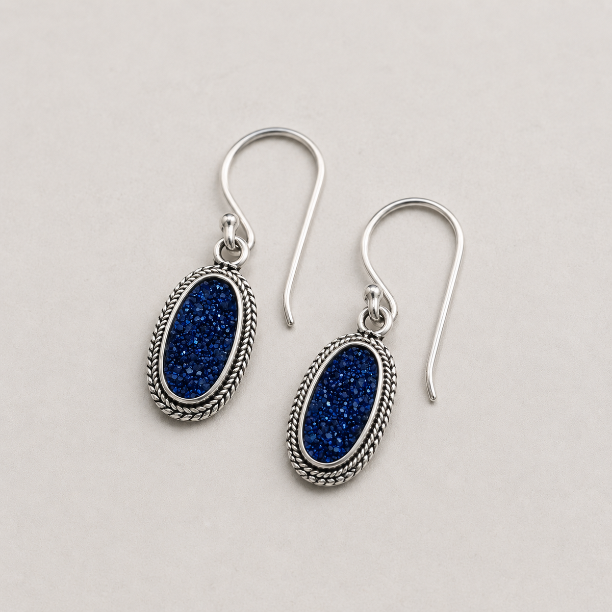 Oval blue druzy earrings with rope-textured silver frame and French hooks