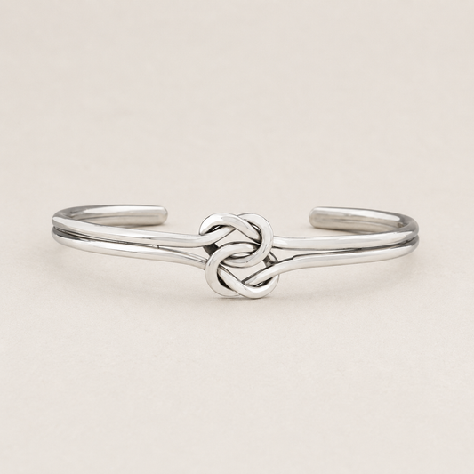Silver cuff bracelet with double-knot chain centerpiece