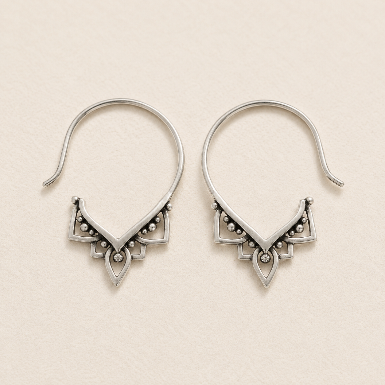 Silver-tone hoop pull-through earrings with ornate triangular beaded detail