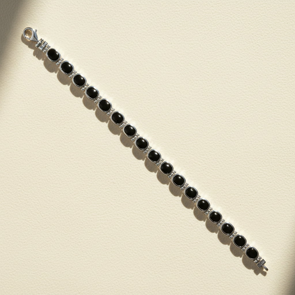 Silver bracelet with black oval cabochons and dark gemstone bar settings