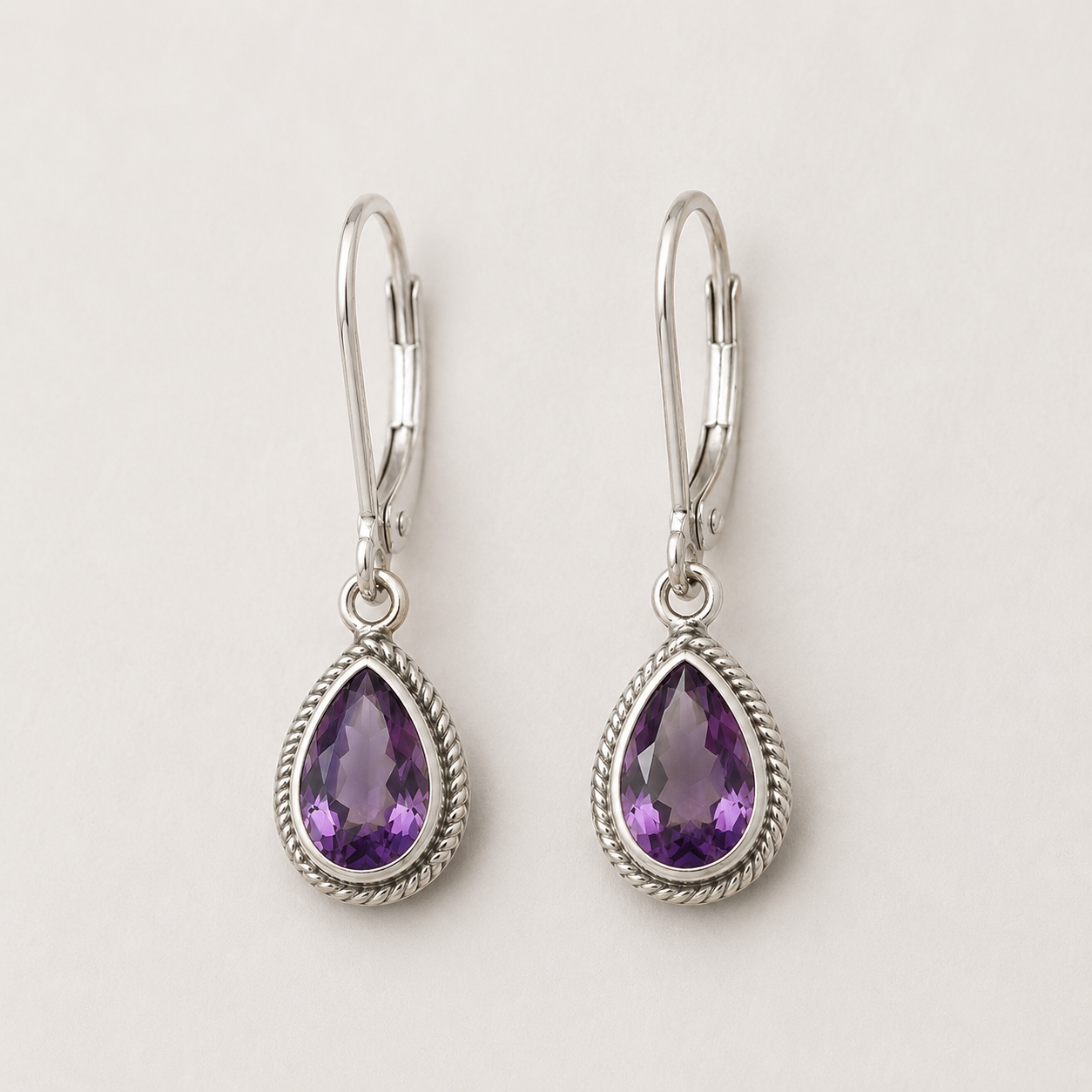 Silver teardrop amethyst earrings with rope-texture bezel and lever hooks