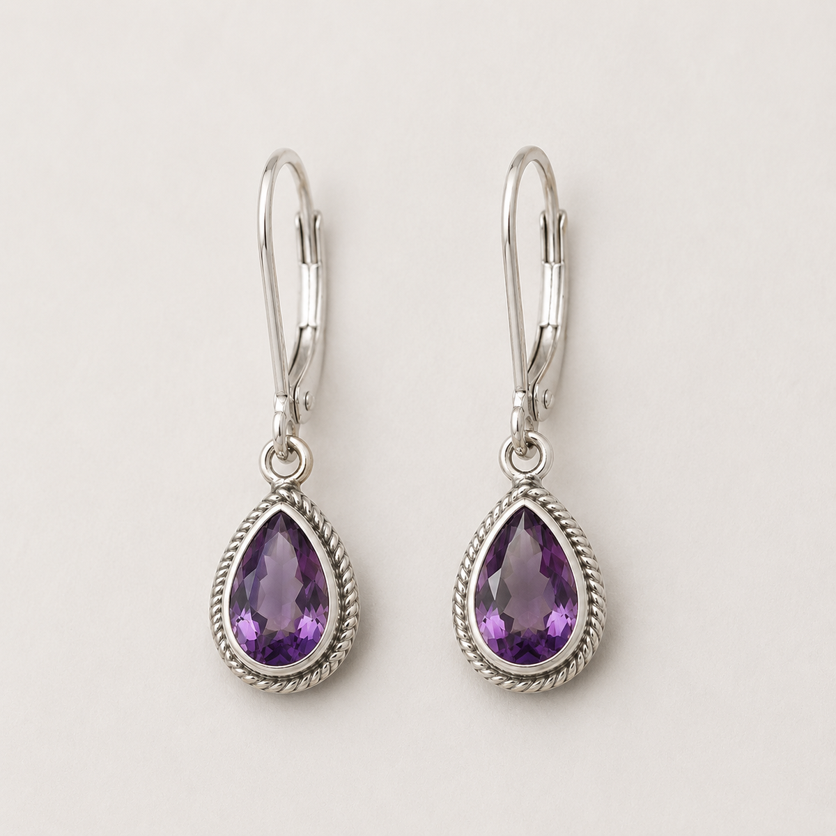 Silver teardrop amethyst earrings with rope-texture bezel and lever hooks