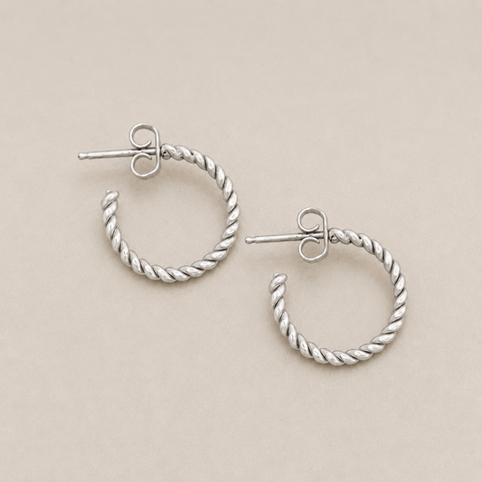 Twisted wire hoop earrings with twisted silver-tone hoops and heart stud posts
