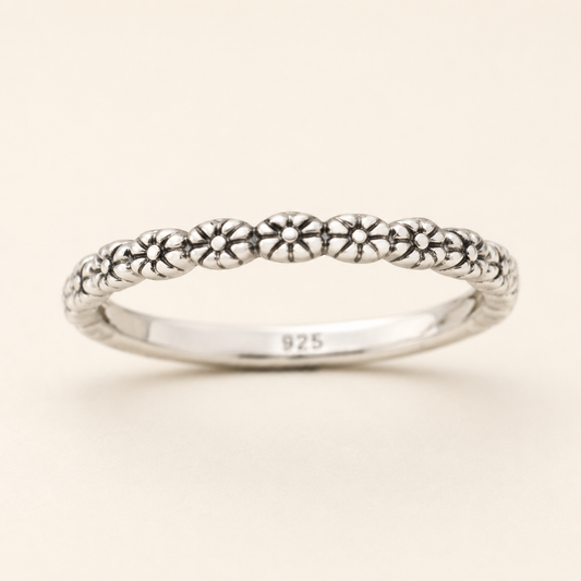 925 sterling silver ring with tiny flower motifs along slim band