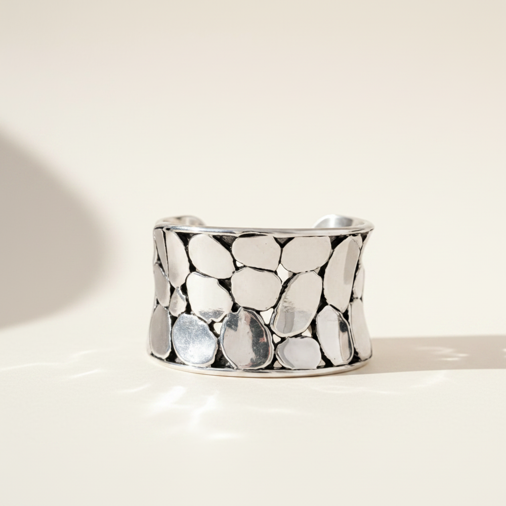 Silver-tone oval pebble-texture ring band, polished metal, wide profile