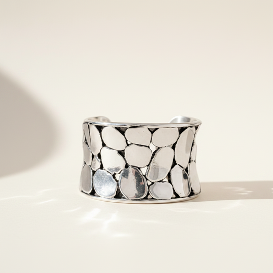 Silver-tone oval pebble-texture ring band, polished metal, wide profile