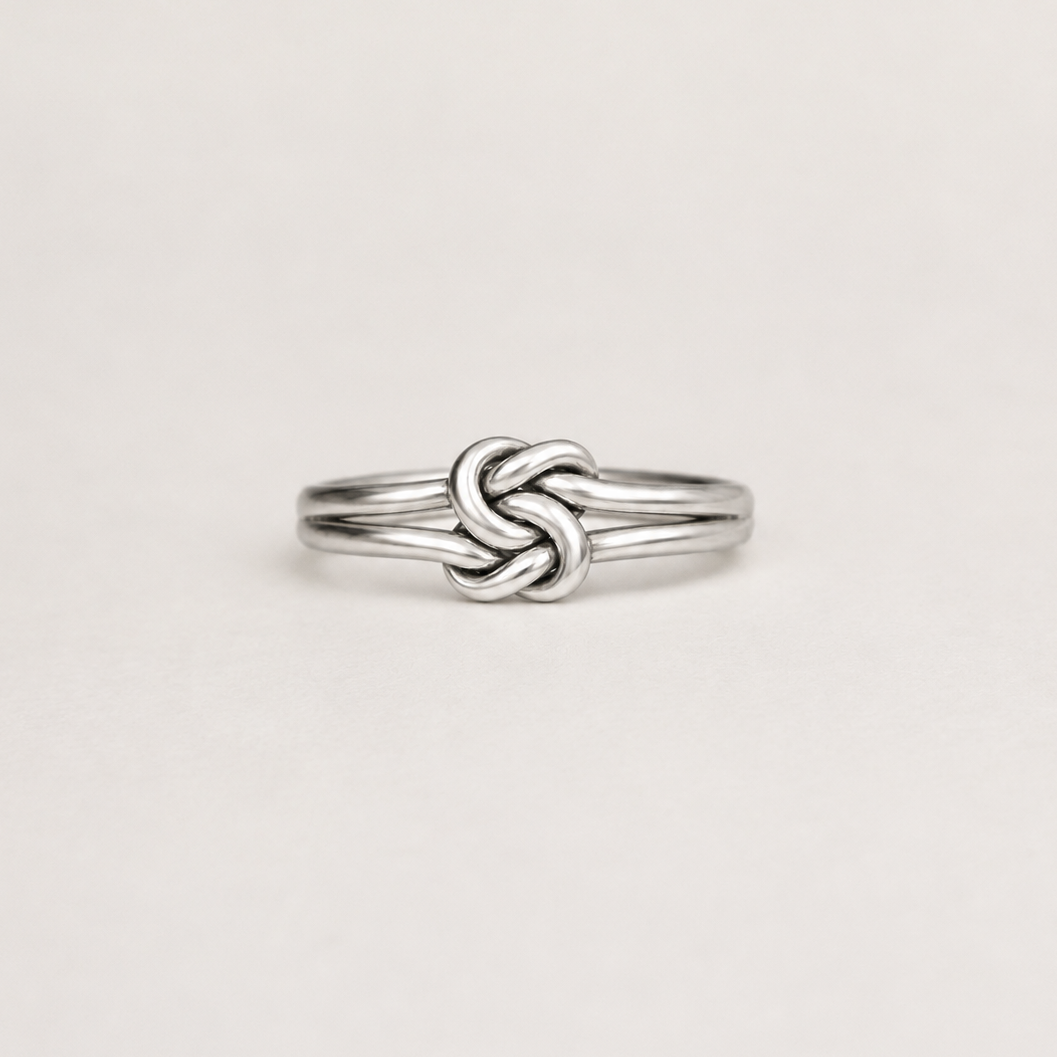 Silver double-knot style ring with polished braided band, slim profile