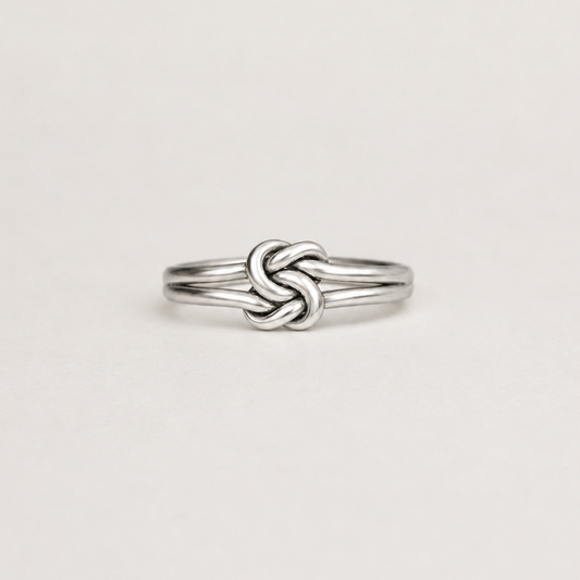 Silver double-knot style ring with polished braided band, slim profile