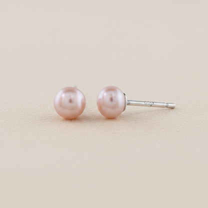 Large pink pearl stud earrings with smooth round pearls on post backs