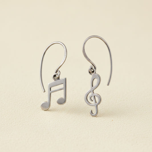 Silver-tone dangle earrings with music note and treble clef charms