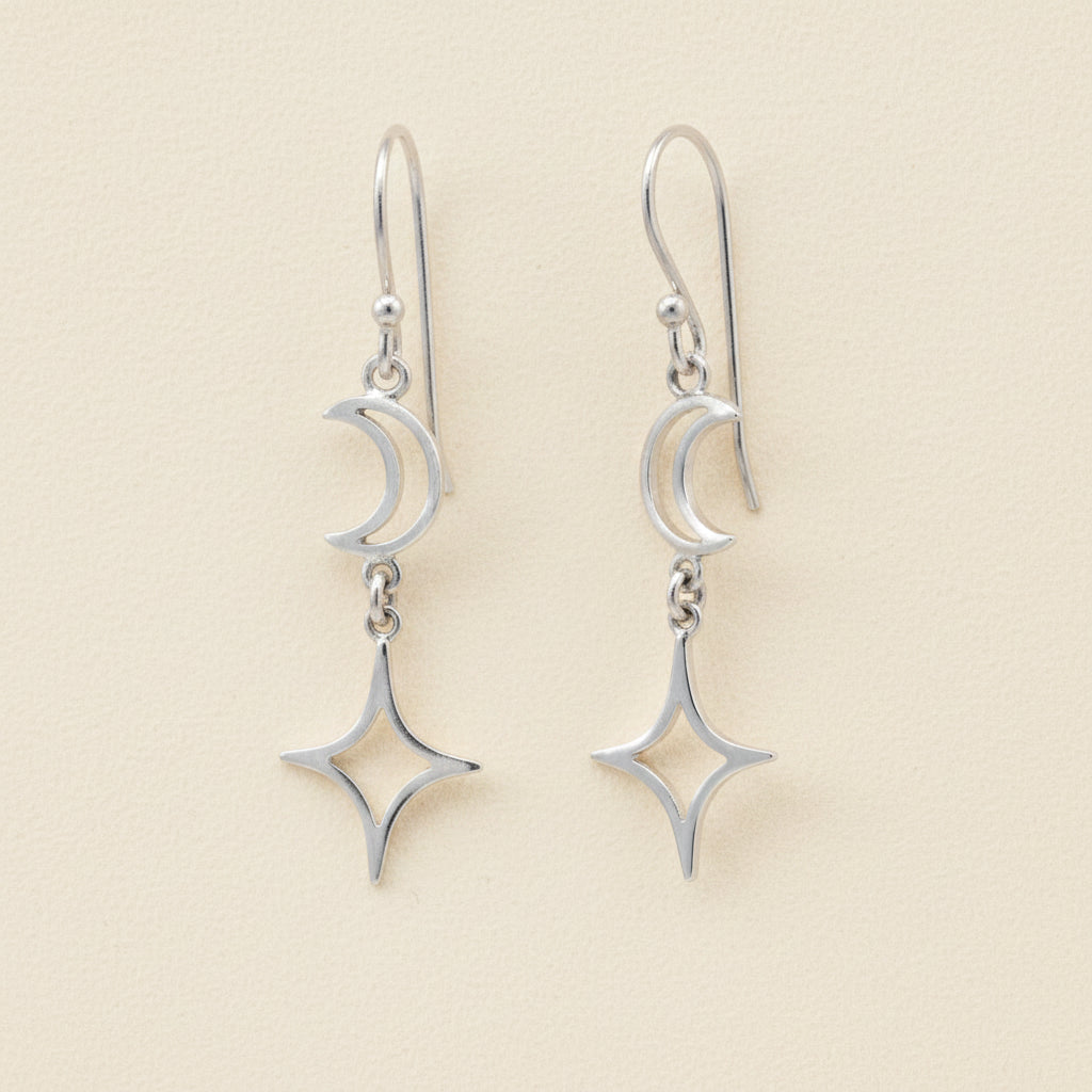 Silver-tone dangle earrings with crescent moon and star charms on linked hooks