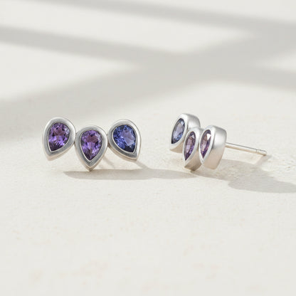 Amethyst pear gemstone stud earrings with three teardrop studs in silver-tone.