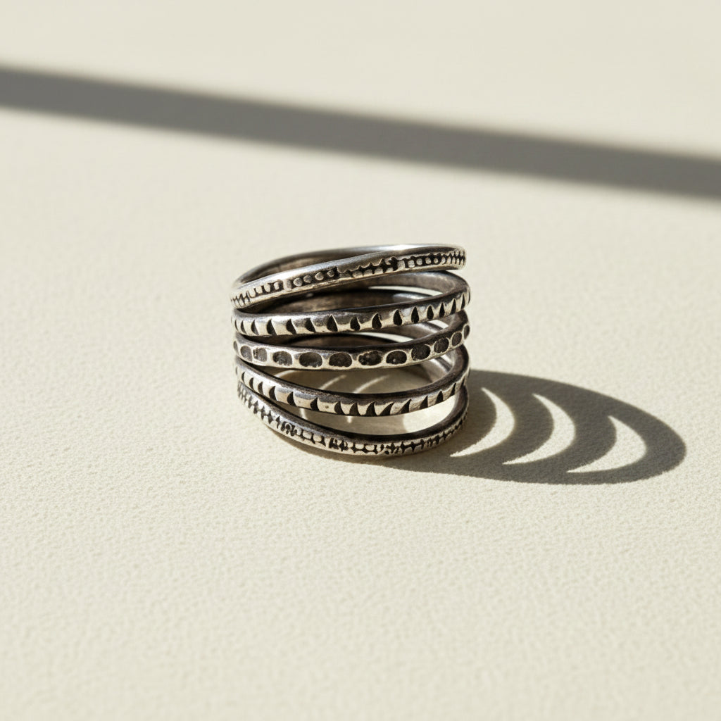 Sterling silver-tone stack ring with five textured bands and carved patterns