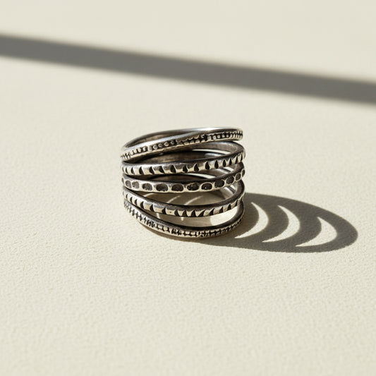 Sterling silver-tone stack ring with five textured bands and carved patterns