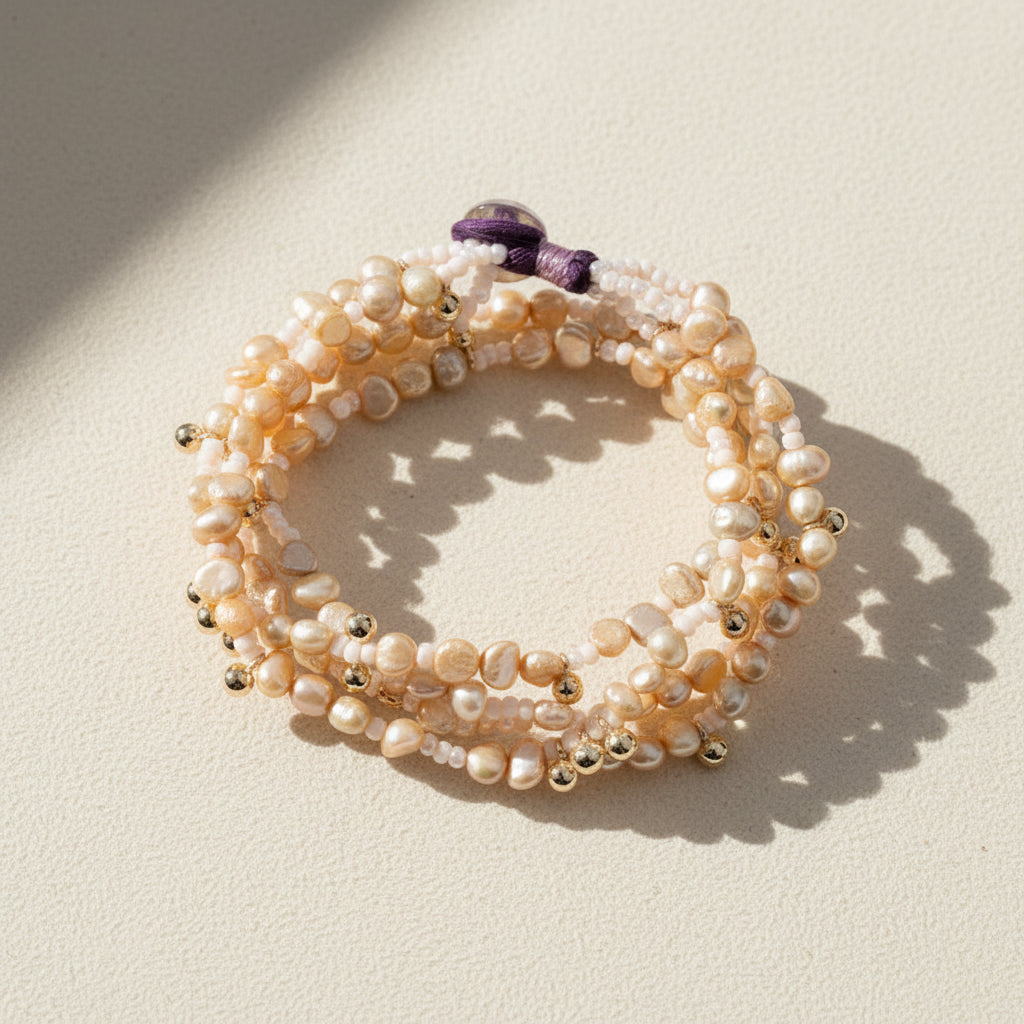 Luminaria beaded pearl bracelet with gold-toned spacers and purple clasp