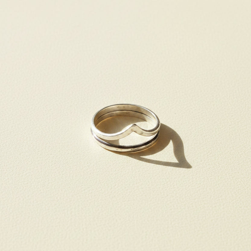 Silver-tone contoured band ring with curved center notch