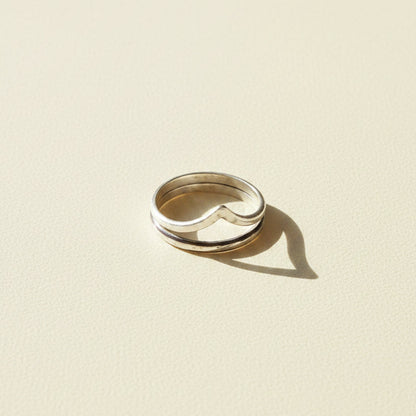 Silver-tone contoured band ring with curved center notch