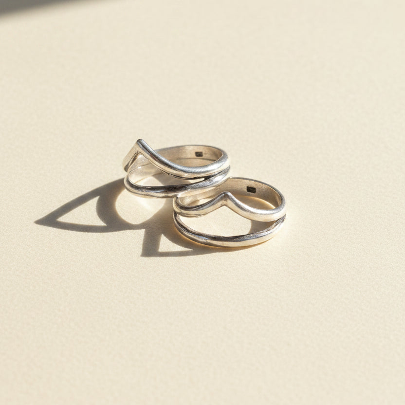 Pair of silver-tone stacked rings with talon-shaped top detail