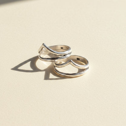 Pair of silver-tone stacked rings with talon-shaped top detail