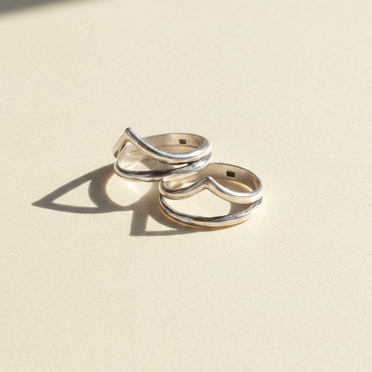 Pair of silver-tone stacked rings with talon-shaped top detail