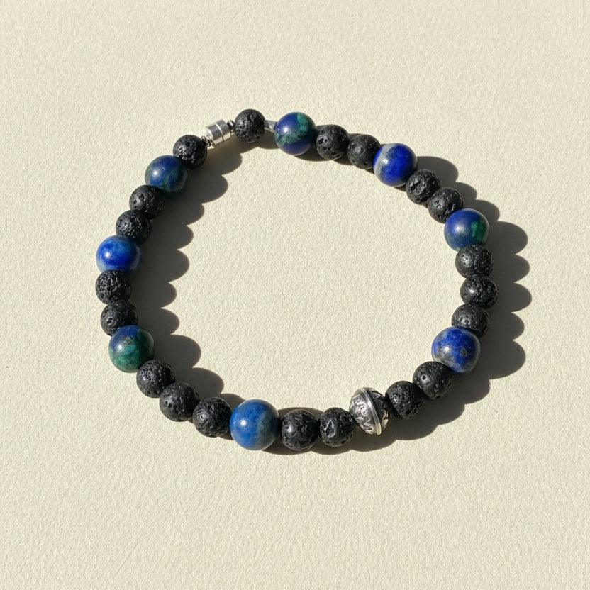 Beaded bracelet of dark lava stones with blue and green glass beads, silver clasp