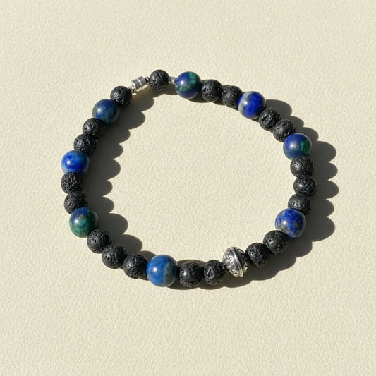 Beaded bracelet of dark lava stones with blue and green glass beads, silver clasp
