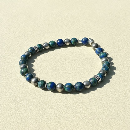 Beaded stretch bracelet with blue and green beads and silver spacers