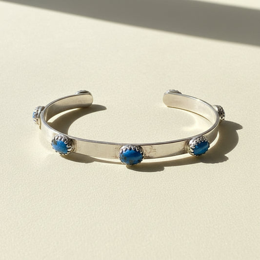 Silver denim cuff bracelet with three blue bead stones and textured metal ends
