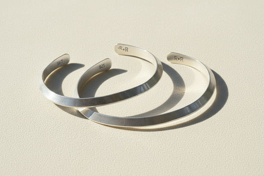 Silver cuff bracelet with engraved inner marking, open V-shaped profile