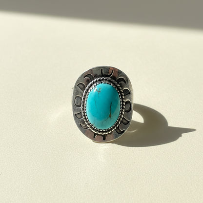Turquoise oval cabochon silver-toned ring with engraved side details, size 11