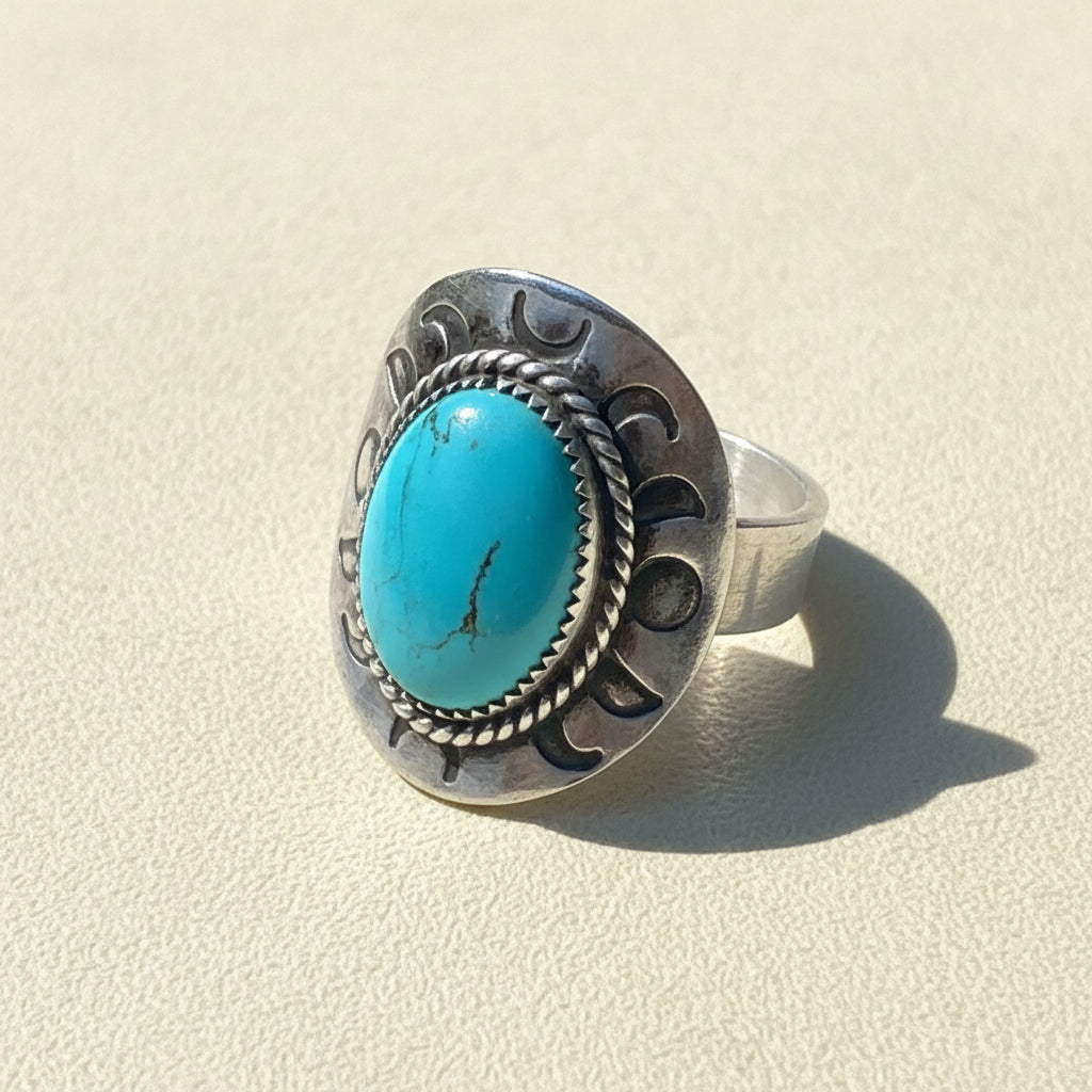 Turquoise oval cabochon silver-toned ring with rope bezel and carved band, size 11