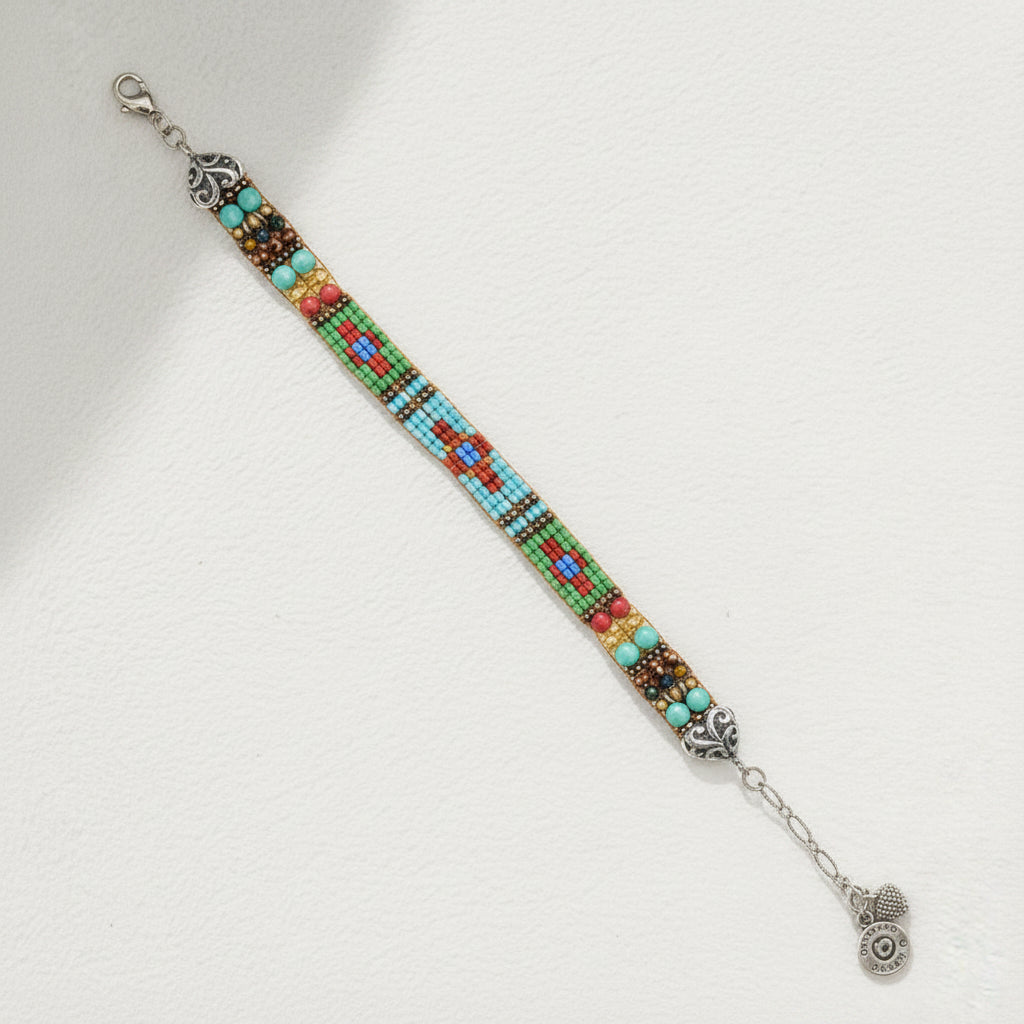 Multicolored beaded bracelet with silver clasp on a white background