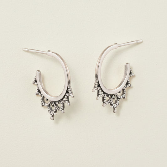 Oxidized filigree hoop earrings with small dangling charms and bead-like details