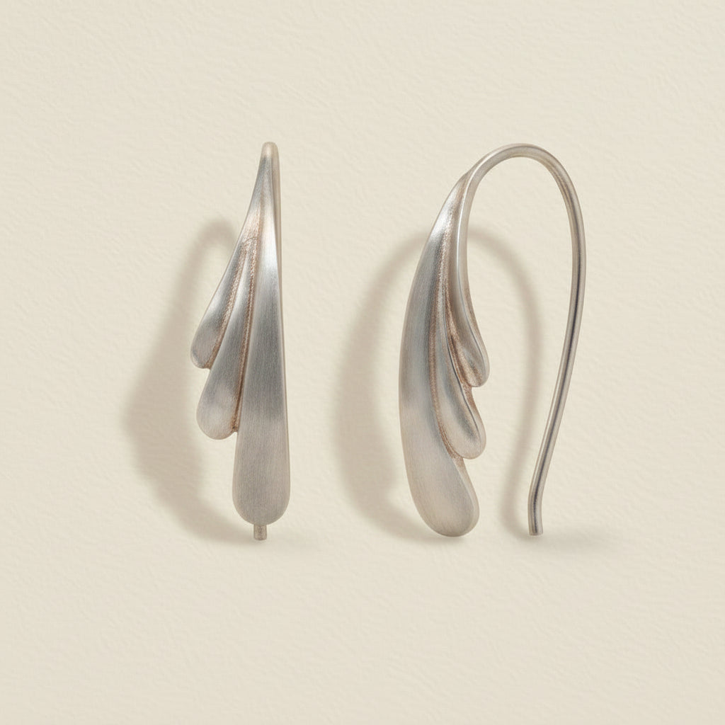 Silver pull-through hoop earrings with feather drop charm