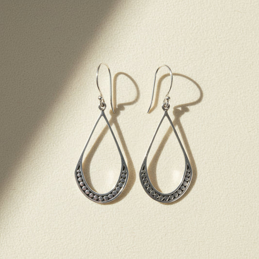 Small silver teardrop beaded earrings with textured border and hanging hook