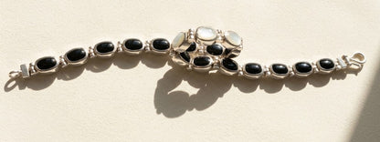 Silver bracelet with black oval cabochons in a linked row design