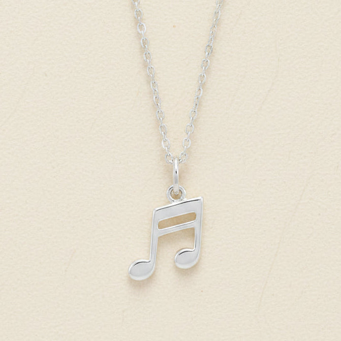Silver-tone musical note pendant necklace with openwork note charm on a chain